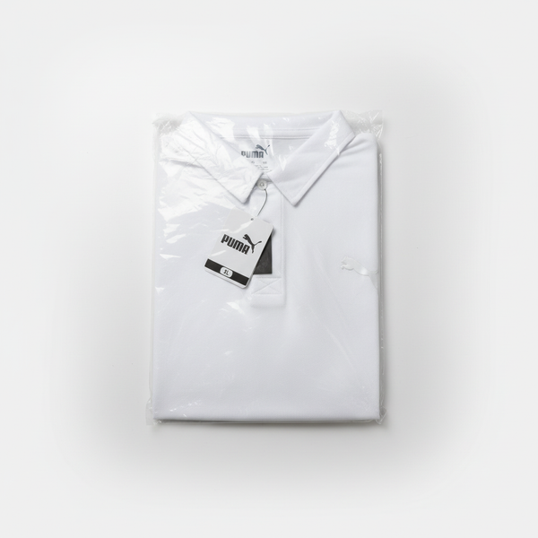 White PUMA Men's DryCELL performance polo shirt folded in packaging.
